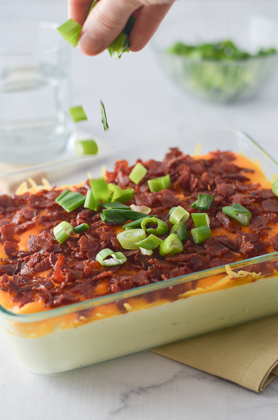 A delicious loaded cauliflower mash that rivals any good mashed potato recipe. Complete with tons of cheddar cheese, generous amounts of crispy bacon and lots of tangy green onions. You will certainly not miss those carb-filled potatoes, and may even impress some of your friends! Nightshade-free, low-carb, ketogenic, gluten-free, grain-free. 