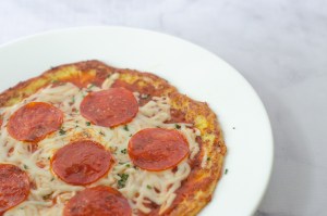 An incredibly simple two-ingredient skillet pizza recipe that is much simpler and faster than a traditional pizza. Made entirely on the stove, it's great for those without a working oven, or if you desire something a little different! Gluten-free, grain-free, low-carb, ketogenic.  