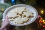 butter cookies in Christmas shapes on a plate in front of a Christmas tree