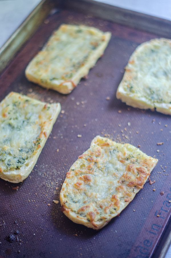 This grain-free cheesy garlic bread is so delicious that everyone will ask for seconds! Crunchy, cheesy and filled with ooey-gooey roasted garlic. 